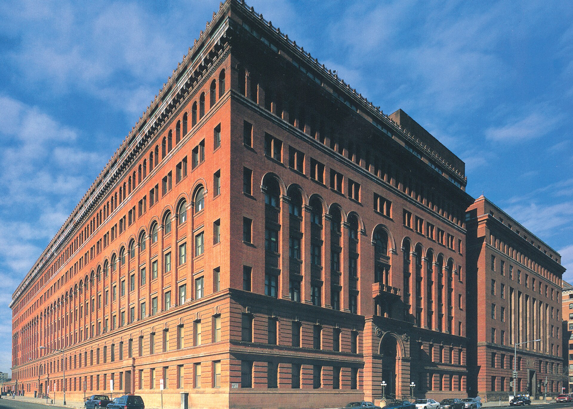 The red brick headquarters of the U.S. Government Publishing Office in Washington, D.C., seen from the street corner against a blue sky
